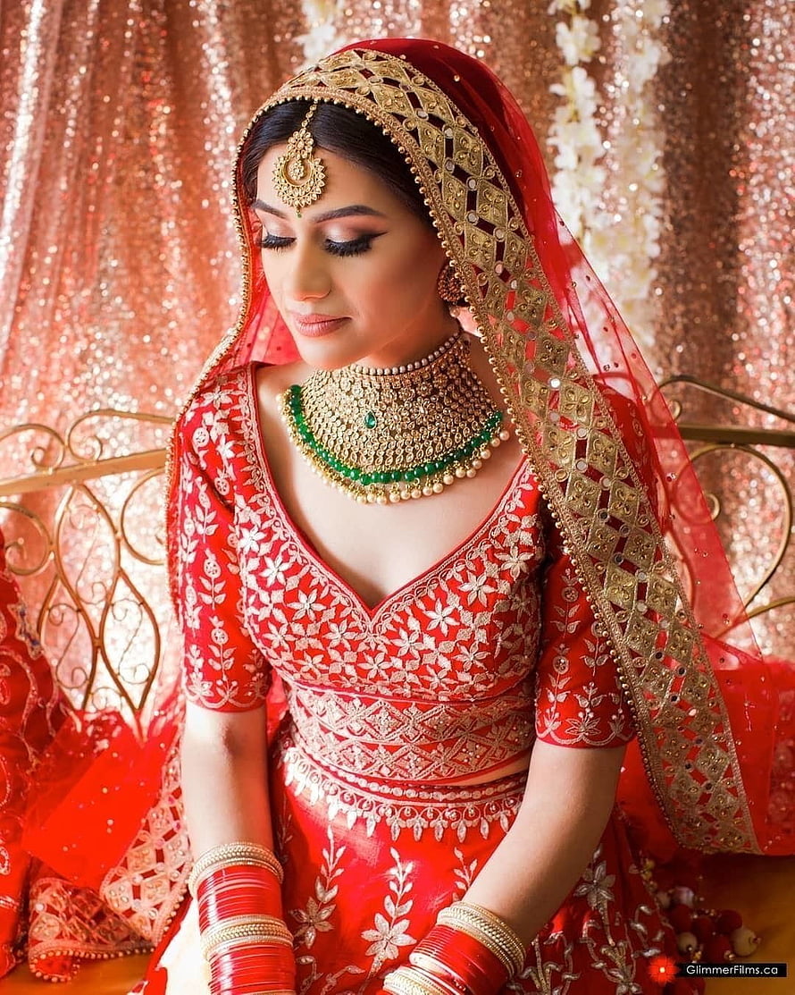 Elegant Indian Bride in Red Lehenga with Gold Jewelry and Dupatta HD phone wallpaper