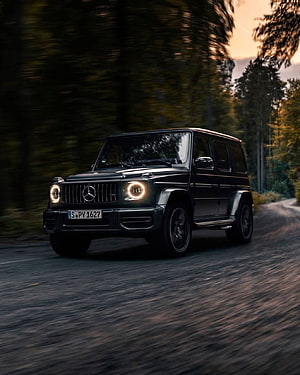 Black Mercedes-Benz G-Class AMG Driving on Forest Road at Sunset HD phone wallpaper