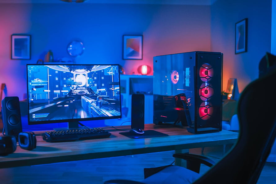 Neon-lit gaming setup with RGB PC tower and curved monitor in a modern home office HD wallpaper