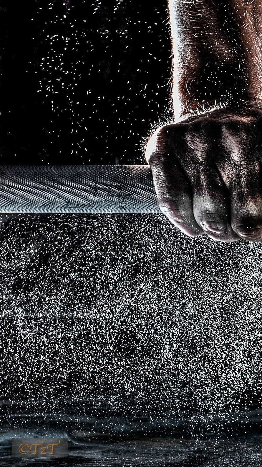 Close-up of a muscular hand gripping a barbell with water droplets splashing against a dark background HD phone wallpaper