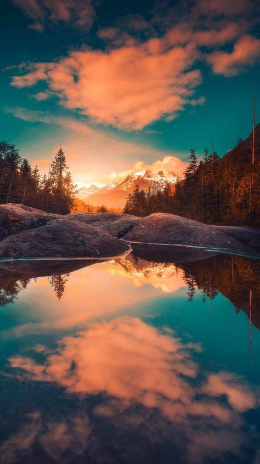 Serene Mountain Lake Reflection at Sunset with Orange Clouds and Pine Forest HD phone wallpaper