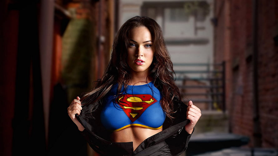 Megan Fox as Supergirl Revealing Blue Costume Under Black Jacket in Urban Alley HD wallpaper