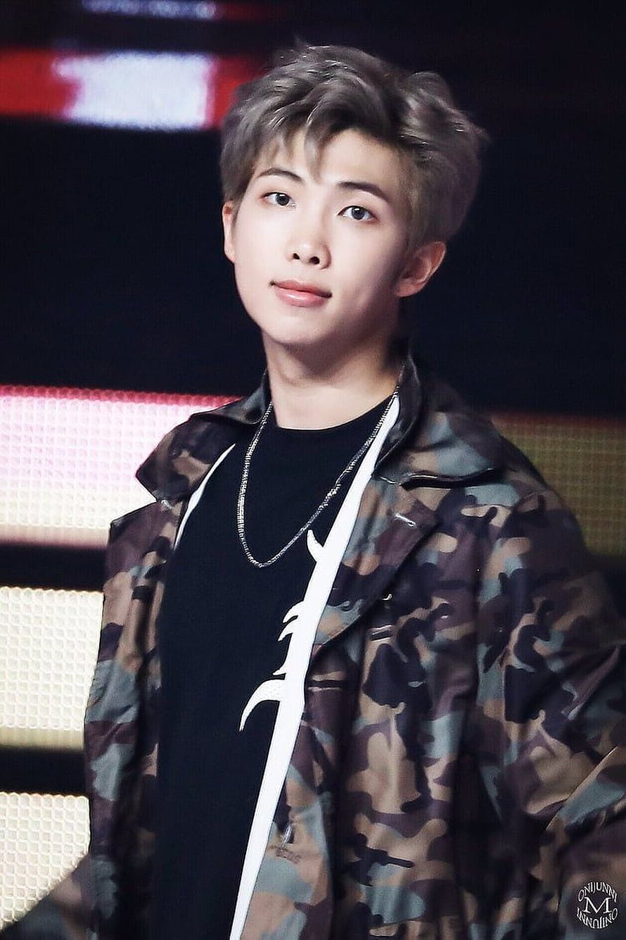 RM from BTS in a camo jacket and black tee with silver chain at a stage event HD phone wallpaper