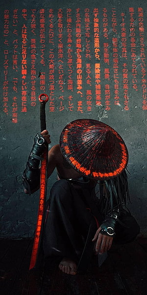 Mysterious warrior in conical hat holding glowing red sword against dark wall with Japanese text HD phone wallpaper