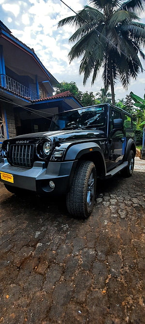Black Mahindra Thar SUV Parked on Cobblestone Road with Tropical Palm Trees HD phone wallpaper