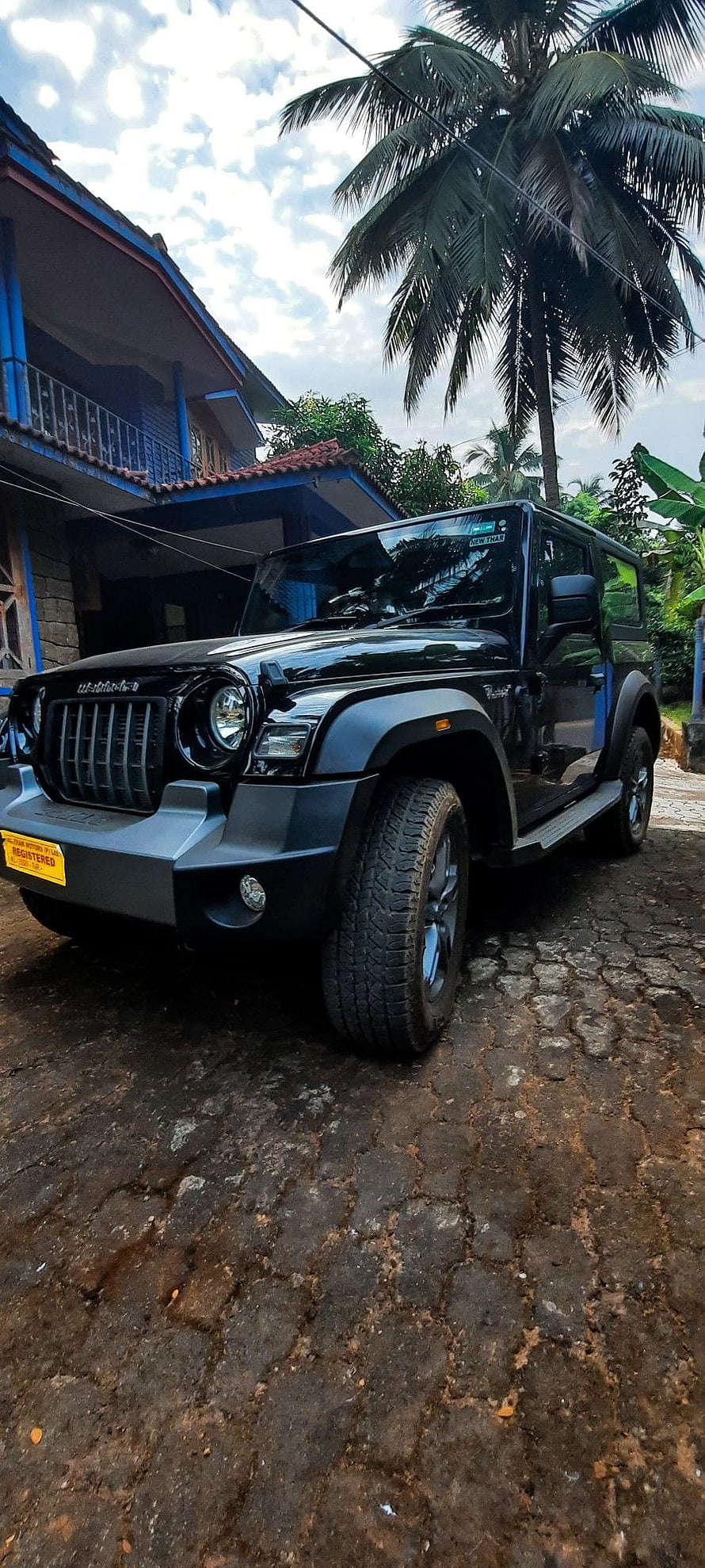 Black Mahindra Thar SUV Parked on Cobblestone Road with Tropical Palm Trees HD phone wallpaper