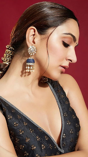 Kiara Advani in a black embroidered dress with traditional jewelry and elegant makeup HD phone wallpaper