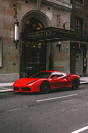 Red Ferrari 488 GTB parked on city street in front of 520 Park Avenue building entrance HD phone wallpaper