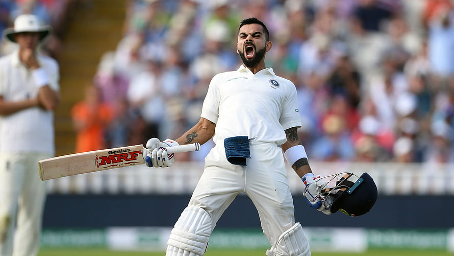 Virat Kohli Celebrating a Milestone in White Cricket Gear HD wallpaper