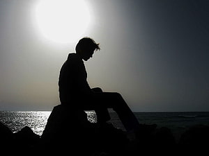 Silhouette of a man sitting on rocks by the ocean at sunset, Sad . Sad , Sad Naruto and Sad Love, Sad Men HD wallpaper