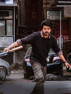 Thalapathy Vijay in Veera Action Scene with Pistol and Urban Street Background HD phone wallpaper