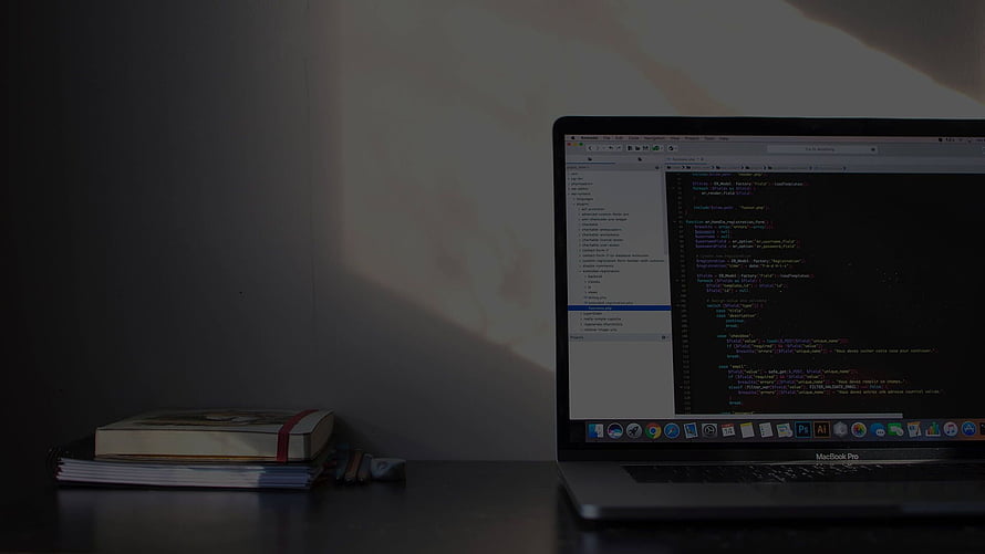 Minimalist Dark Workspace With Laptop Showing Code Editor And Stack Of Books HD wallpaper