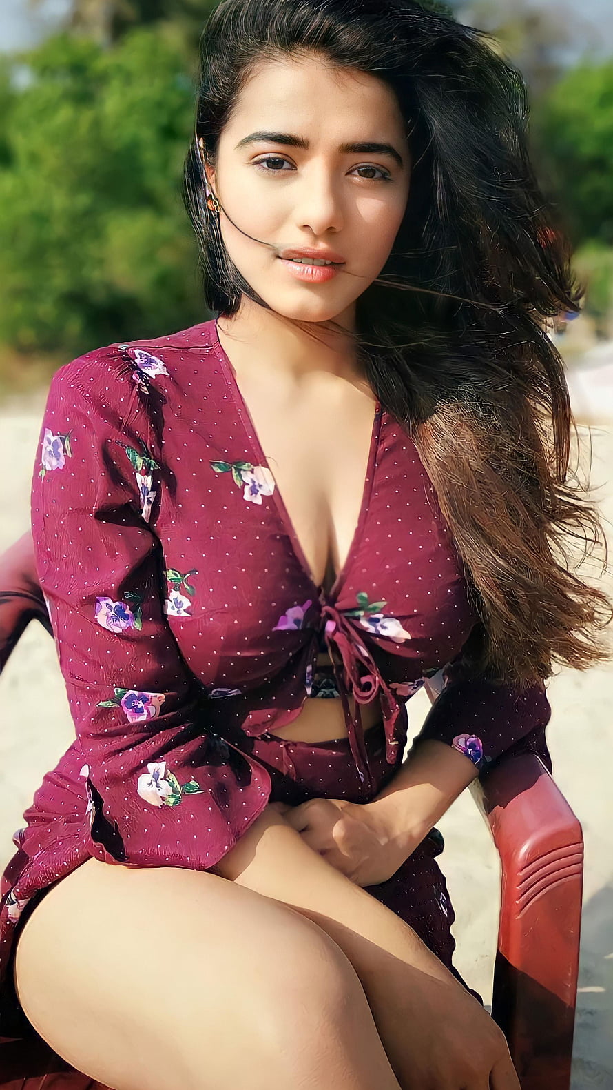 Portrait of a woman in a maroon floral dress sitting outdoors, Ketika sharma, telugu actress, model, cute face HD phone wallpaper