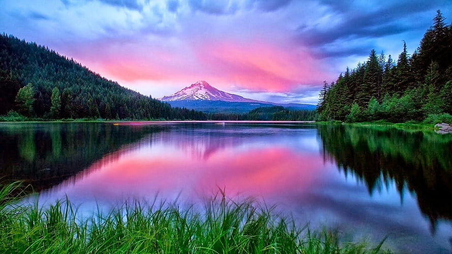 Snow-capped mountain reflected in a calm lake at sunset with pink and purple sky HD wallpaper