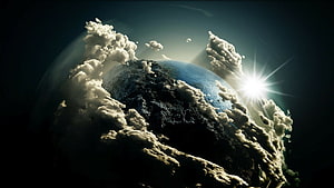 Dramatic Planet Earth Surrounded by Clouds with Bright Sun Flare in Space HD wallpaper