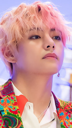 V from BTS with pink hair wearing a colorful patterned jacket and white shirt HD phone wallpaper
