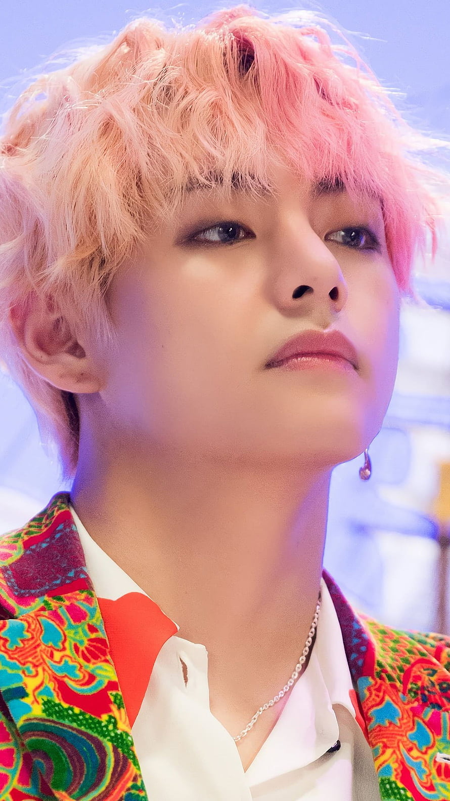 V from BTS with pink hair wearing a colorful patterned jacket and white shirt HD phone wallpaper