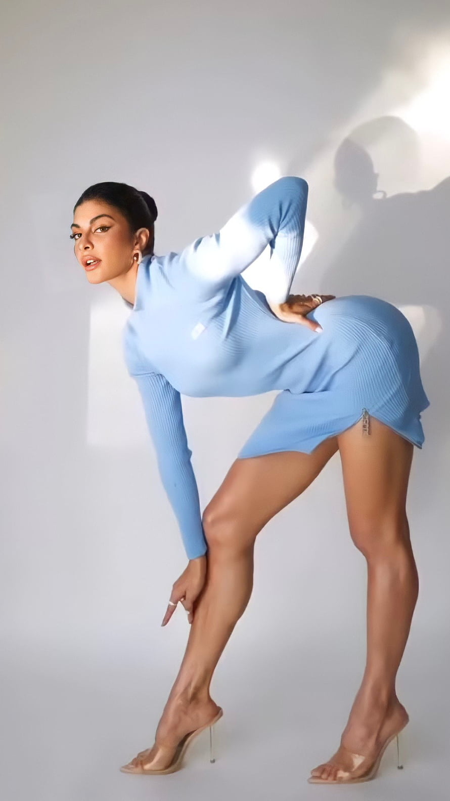 Jacqueline Fernandez in a light blue ribbed dress posing against a white studio backdrop HD phone wallpaper