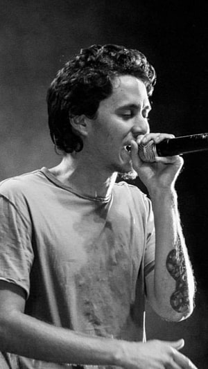 Canserbero performing live on stage in black and white portrait HD phone wallpaper