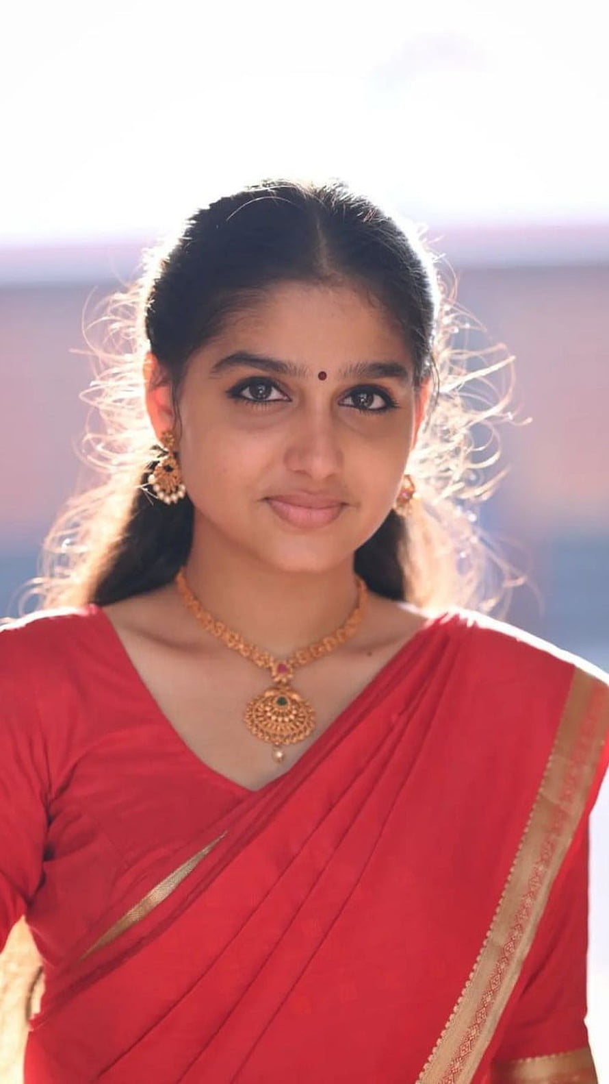 Anaswara Rajan in a red saree with gold jewelry and traditional Indian styling HD phone wallpaper