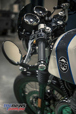Close-up of a custom Triumph motorcycle handlebar with analog gauges and tank logo HD phone wallpaper
