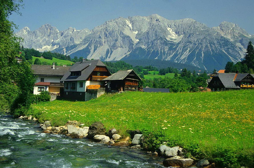 Alpine Village with Traditional Chalets and Mountain Backdrop HD wallpaper