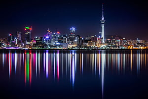 Auckland Skyline at Night with Sky Tower and Harbour Reflections HD wallpaper
