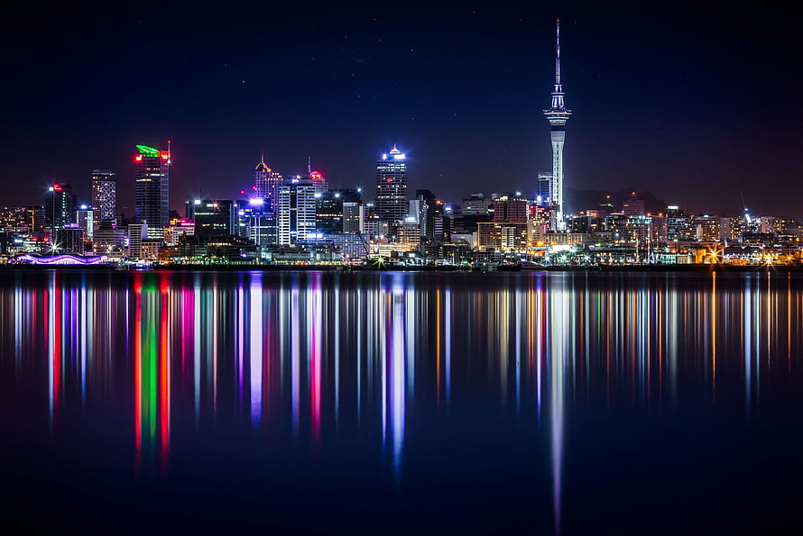 Auckland Skyline at Night with Sky Tower and Harbour Reflections HD wallpaper