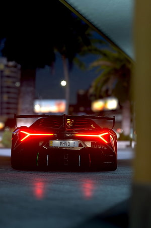 Lamborghini Sian rear view with glowing red taillights and large spoiler at night HD phone wallpaper