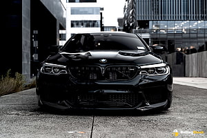 Black BMW M5 Competition F90 Front View in Urban Setting HD wallpaper