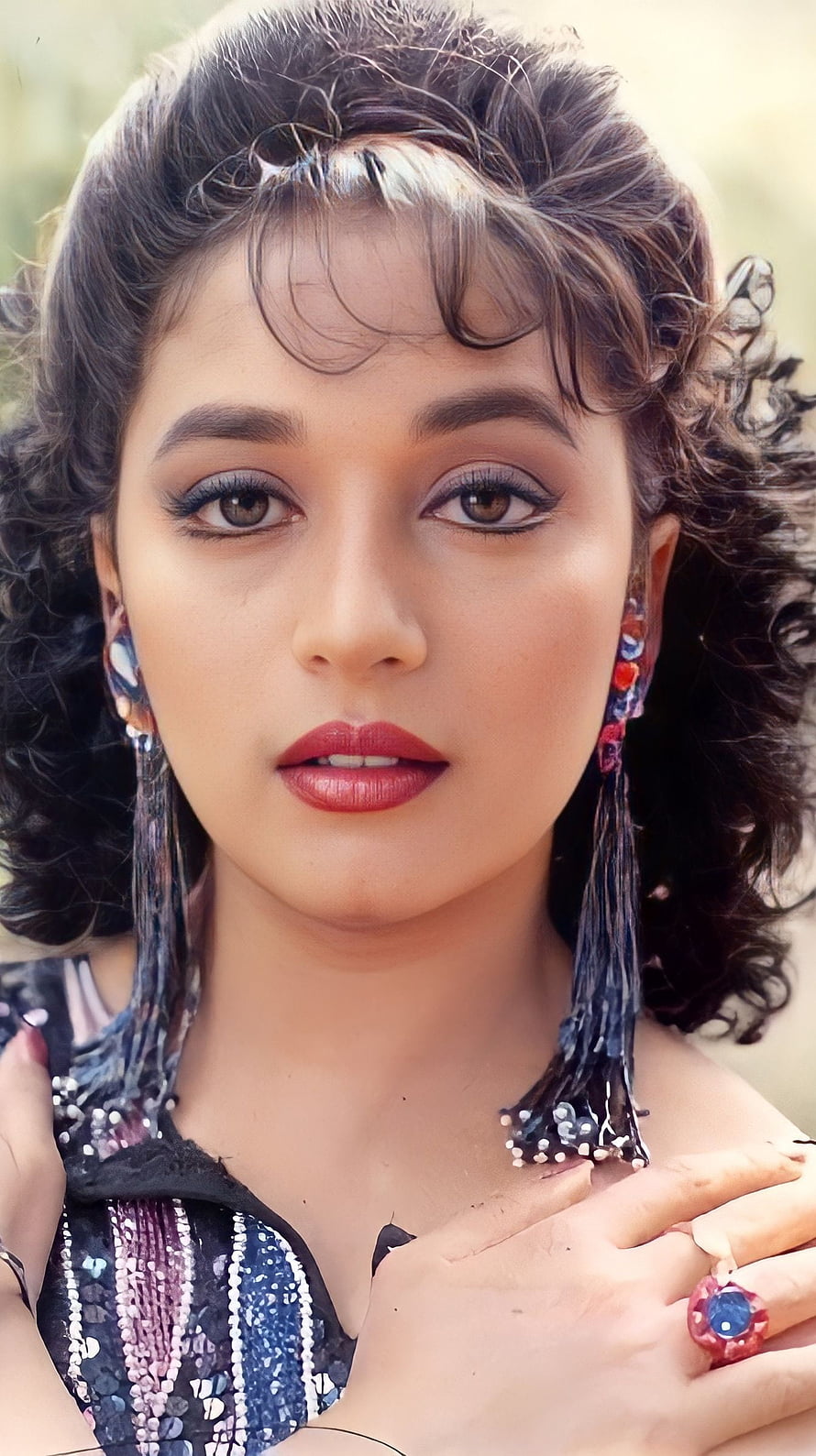Portrait of a woman with curly hair, bold makeup, and colorful tassel earrings, Madhuri Dixit, bollywood actress HD phone wallpaper