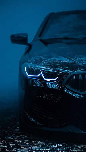 Close-up of BMW Headlight with Blue Neon Glow in Dark Foggy Atmosphere HD phone wallpaper