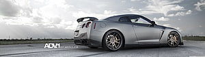 Silver Nissan GT-R R35 Rear Three-Quarter View on Open Asphalt Track HD wallpaper