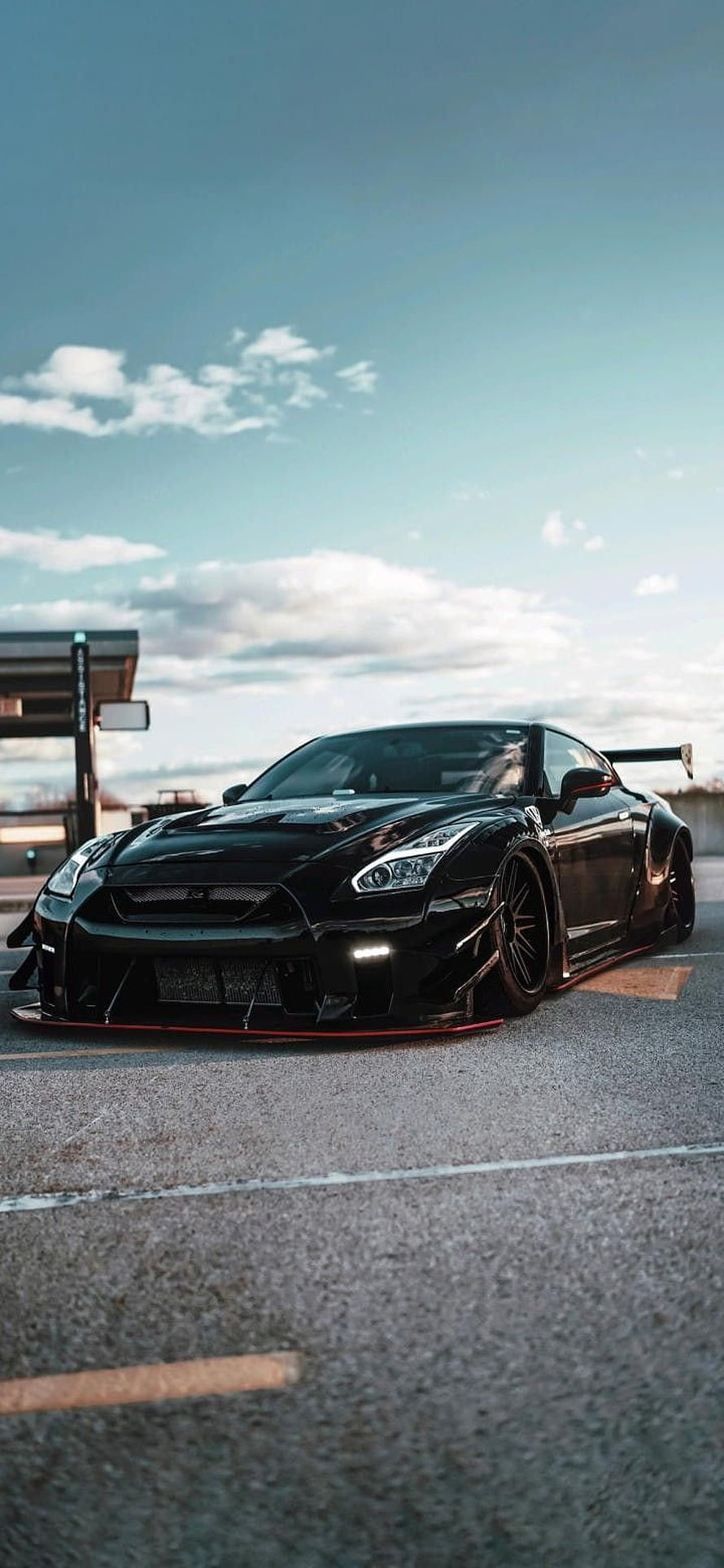Black Nissan GT-R R35 Widebody with Red Accents and Large Rear Wing on Asphalt HD phone wallpaper