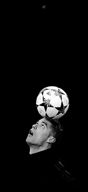 Cristiano Ronaldo balancing a soccer ball on his head in black and white HD phone wallpaper