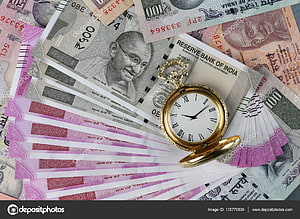 Vintage gold pocket watch resting on a fan of Indian rupee banknotes HD wallpaper