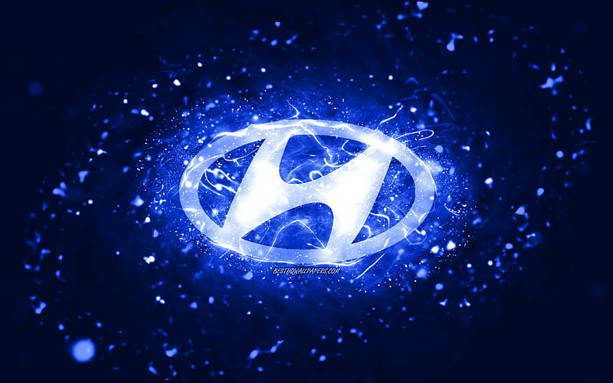 Glowing Hyundai emblem with electric blue energy burst and particle effects on a dark abstract background HD wallpaper