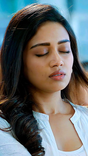 Nivetha Thomas Serene Portrait With Closed Eyes And Flowing Hair HD phone wallpaper