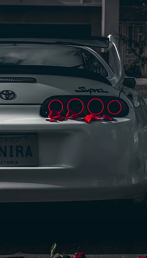 White Toyota Supra Rear View With Red Rose Petals And Glowing Taillights HD phone wallpaper