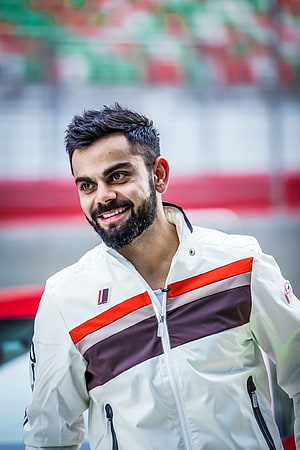 Virat Kohli smiling portrait wearing white racing jacket with red and purple stripes HD phone wallpaper