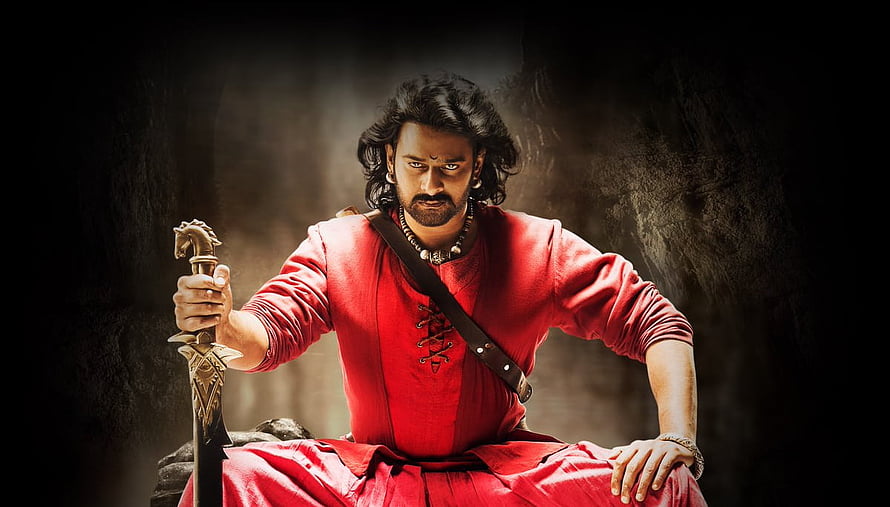 Prabhas as Baahubali in Red Attire Holding Sword in Dramatic Pose HD wallpaper