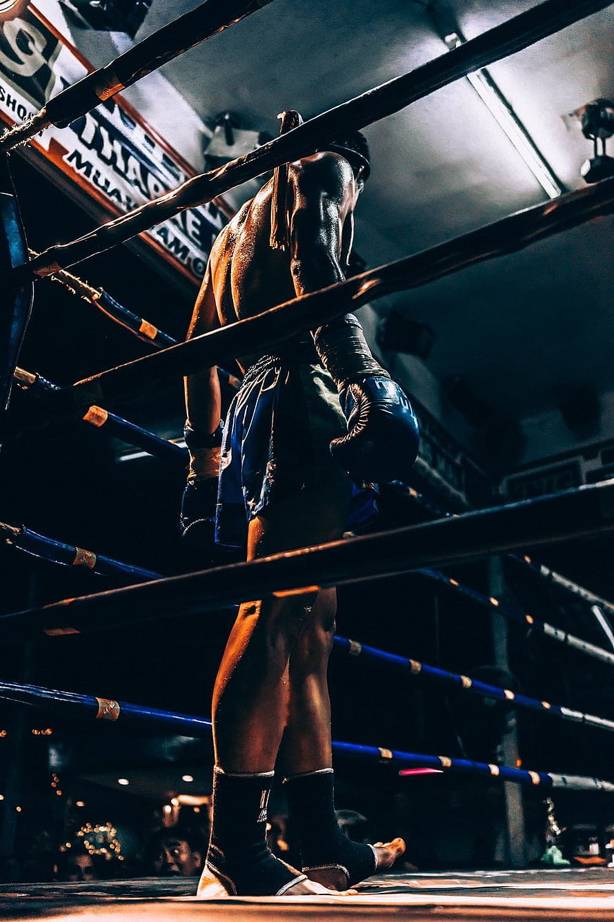 Muay Thai Fighter Standing in the Ring with Blue Gloves and Traditional Shorts HD phone wallpaper