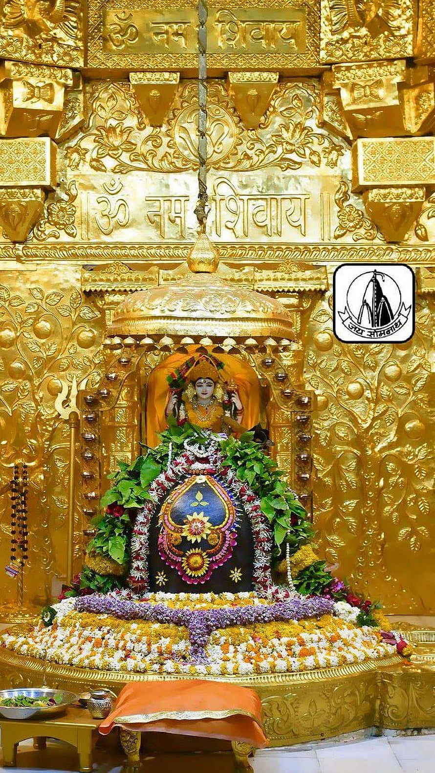 Somnath Mahadev Temple Golden Shrine with Flower Offerings and Sanskrit Inscriptions HD phone wallpaper