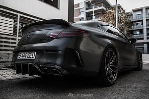 Matte Black Mercedes-AMG C63 S Coupe Rear View with Carbon Fiber Spoiler and Exhaust HD wallpaper
