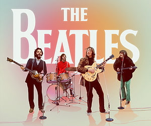 The Beatles performing live with guitars and drums on stage HD wallpaper