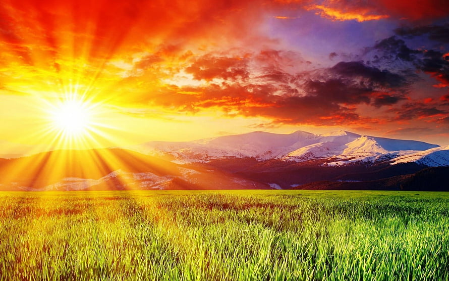 Vibrant Sunrise Over Snow-Capped Mountains and Green Grassland with Dramatic Clouds HD wallpaper