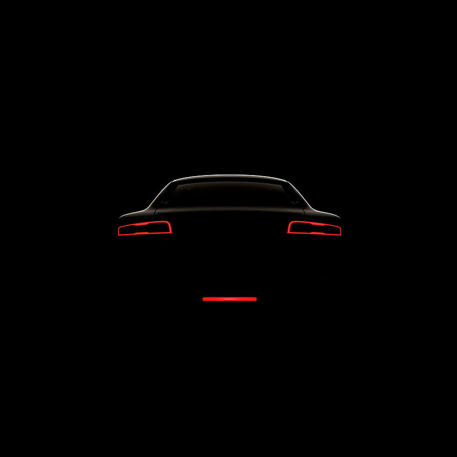Minimalist Rear View of a Car Silhouette with Glowing Red Taillights Against a Black Background HD phone wallpaper