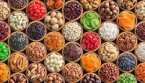 Colorful Assortment of Nuts and Dried Fruits in Wooden Bowls HD wallpaper
