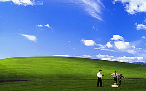 Three Men Playing Cricket on a Green Hill Under Blue Sky HD wallpaper