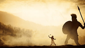 David And Goliath Silhouette Confrontation in Golden Misty Landscape HD wallpaper